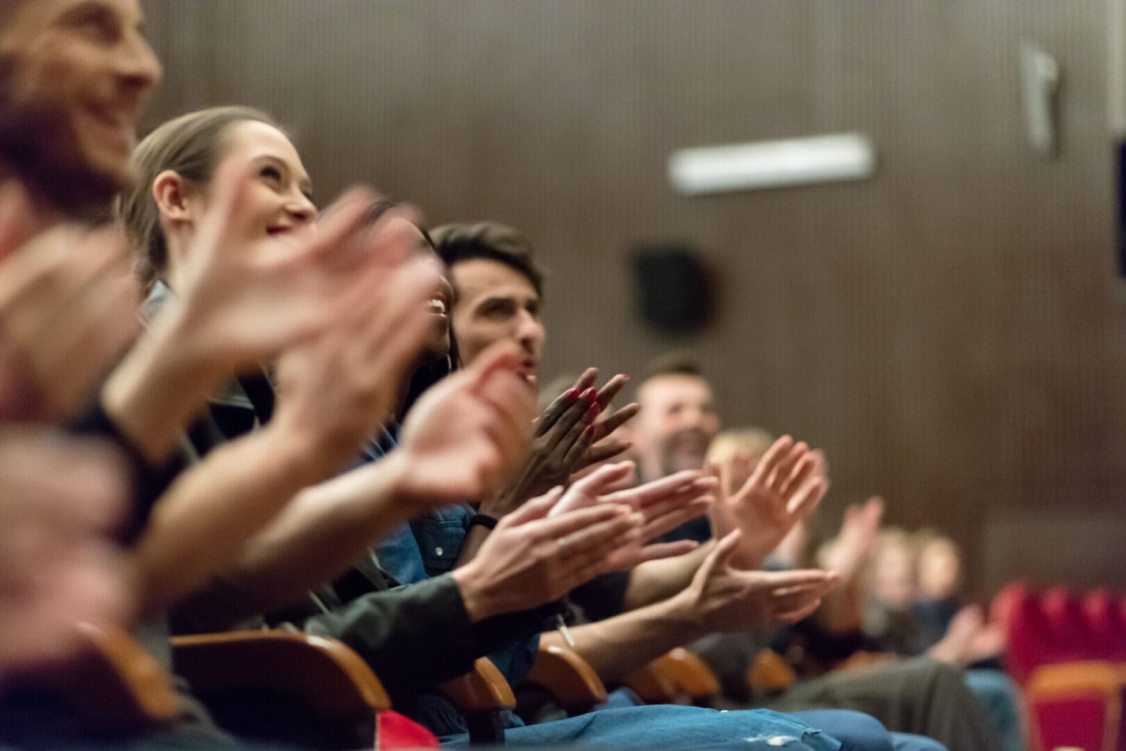 Audience applauding in a theater.